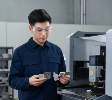 Laser application engineer reviewing sample parts